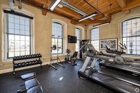 Coventry apartment for rent - A gym with a row of dumbbells on the left and a treadmill on the right.