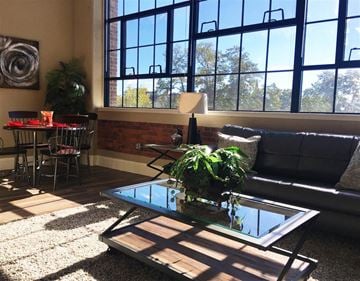 Nashua apartment for rent - A living room with a glass coffee table and a couch.