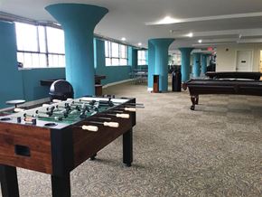 Nashua apartment for rent - A foosball table is in the middle of a room with a pool table in the background.