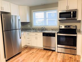 Manchester apartment for rent - a kitchen with stainless steel appliances and white cabinets
