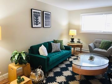 Manchester apartment for rent - a living room with a green couch and a coffee table