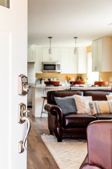 Laconia apartment for rent - an open door leading into a living room with a couch and a kitchen