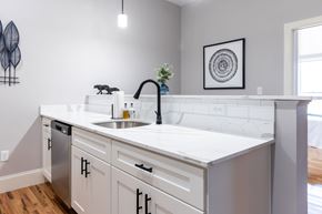 Manchester apartment for rent - A kitchen with white cabinets and a white counter top.