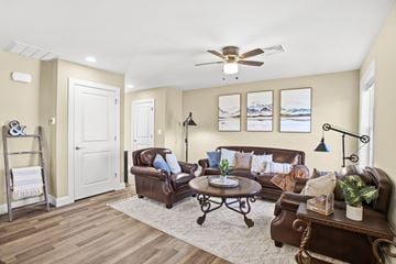 Lebanon apartment for rent - a living room with leather furniture and a ceiling fan