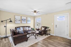 Lebanon apartment for rent - a living room with leather furniture and a ceiling fan