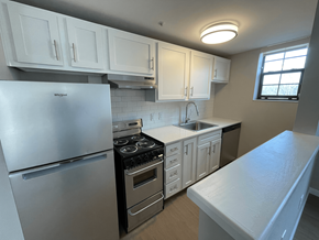 Charlotte apartment for rent - A kitchen with white cabinets and a stainless steel refrigerator.