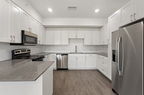 Richland apartment for rent - A modern kitchen with white cabinets and stainless steel appliances.