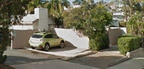 San Diego apartment for rent - a yellow car parked in front of a white wall