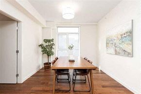 Vancouver condo for rent - A dining room with a wooden table and chairs.