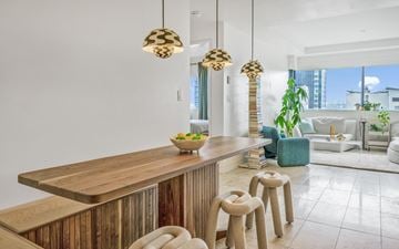Vancouver apartment for rent - A modern kitchen with a wooden counter and stools.