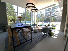 Surrey condo for rent - an open concept living room and dining room with large windows and a view of the pool