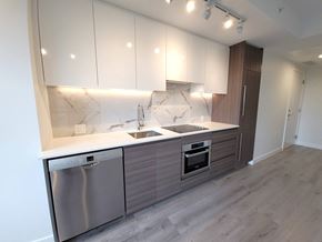 Surrey condo for rent - A modern kitchen with a marble backsplash and stainless steel appliances.