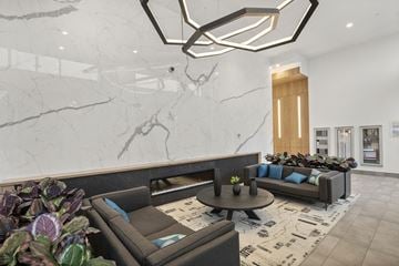 Surrey condo for rent - A modern living room with a grey sofa and a round coffee table.