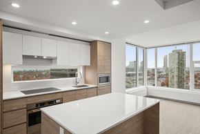 Surrey condo for rent - A modern kitchen with a large island in the middle.