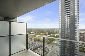 Surrey condo for rent - A view from a high-rise building looking out over a cityscape.