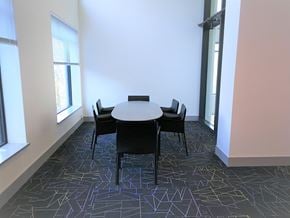 Burnaby condo for rent - A conference room with a table surrounded by chairs.