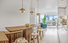 Vancouver apartment for rent - A modern kitchen with a wooden bar and stools.