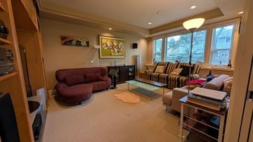 Richmond apartment for rent - A living room with a red chair and a couch.
