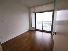 Burnaby apartment for rent - A room with a sliding glass door leading to a balcony.