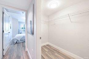Vancouver apartment for rent - a bedroom with a closet and a mirror on the wall