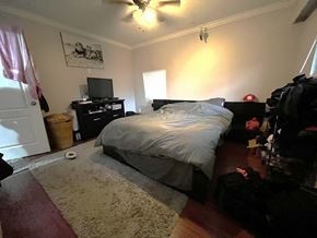 Maple Ridge apartment for rent - A bedroom with a bed, dresser, and ceiling fan.