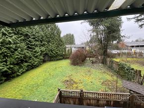 Maple Ridge apartment for rent - A backyard with a wooden fence and a green lawn.