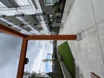 Maple Ridge apartment for rent - A view from below looking up at a wooden beam and concrete wall.