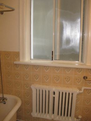 Vancouver apartment for rent - A white radiator is installed under a window in a bathroom.