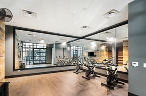 Broomfield apartment for rent - A gym with a mirror on the wall and exercise bikes  at Bridges at Flatiron, Broomfield, 80021