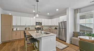 Apex apartment for rent - A modern kitchen with a dining table and chairs.