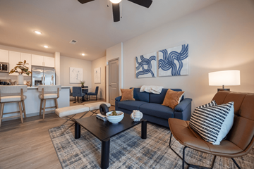 Antioch apartment for rent - A living room with a blue couch and a coffee table.