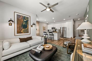 Canton apartment for rent - A modern living room with a white sofa and a painting on the wall.