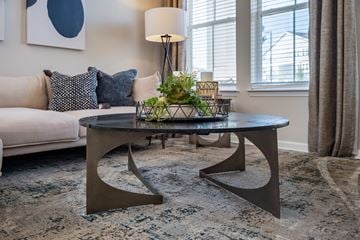 Charlotte apartment for rent - A modern living room with a white sofa and a round coffee table.