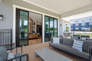 Arden apartment for rent - A modern outdoor living space with a grey sofa and a coffee table.