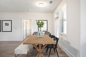 Arden apartment for rent - A dining room with a wooden table and chairs.