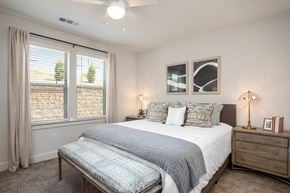 Arden apartment for rent - A bedroom with a large bed and a window with curtains.