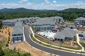 Arden apartment for rent - A large resort with a swimming pool and a mountain in the background.