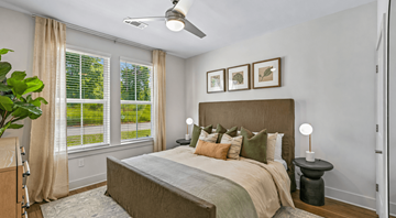 Apex apartment for rent - A bedroom with a large bed and a ceiling fan.