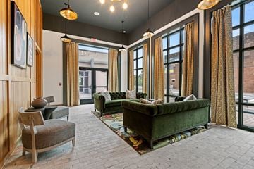 Charleston apartment for rent - a living room with couches and chairs and large windows