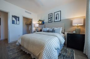 Chester apartment for rent - A bedroom with a large bed and a nightstand with a lamp.