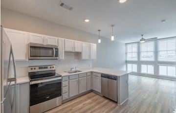 Charleston apartment for rent - A kitchen with white cabinets and stainless steel appliances.