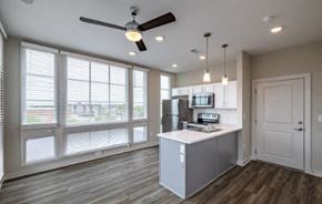 Charleston apartment for rent - A kitchen with a fan and a fridge.