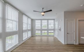 Charleston apartment for rent - A room with a ceiling fan and sliding glass doors.