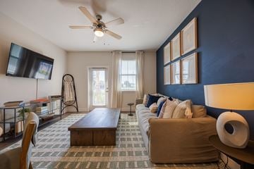 Rockledge apartment for rent - A living room with a brown couch and a ceiling fan.
