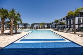 Ruskin apartment for rent - A long rectangular pool with a blue tiled edge and a white tiled edge.