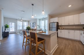 Raleigh apartment for rent - A kitchen with a table and chairs in front of a window.