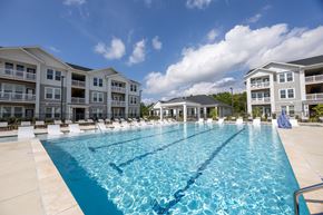 Charlotte apartment for rent - A large swimming pool in front of apartment buildings.