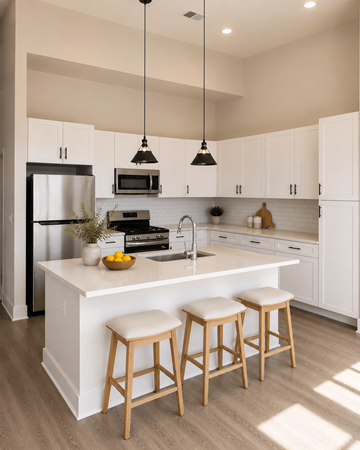 Charlottesville apartment for rent - A kitchen with white cabinets and a white island with two stools.
