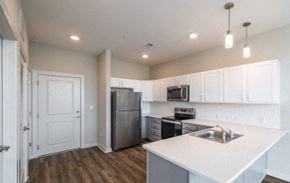 Charleston apartment for rent - A kitchen with white cabinets and a white island.
