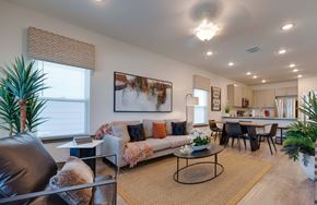 Gainesville townhouse for rent - A living room with a couch, chairs, and a dining table.
